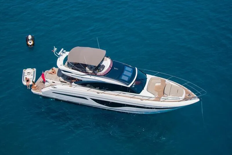 Yacht anchored at a bay in Mallorca. Sunny day. Blue water. Boat for rental in Mallorca.