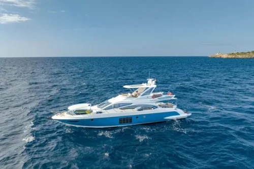 yacht in charter in mallorca. Boat anchored at a bay. Spacious Flybridge. Sunny day.