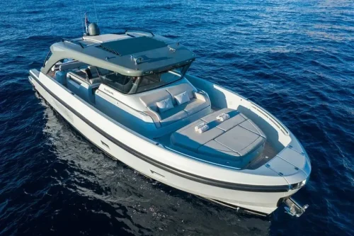 yacht in charter in Mallorca anchored at a bay. New yacht. Spacious sofa area with cushions.