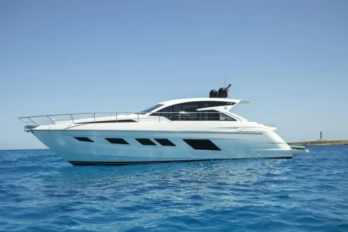 Yacht in charter in Mallorca anchored at a bay. Boat is white and see is light blue. Sunny day.