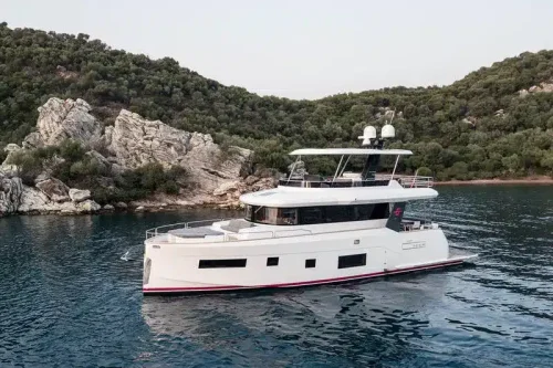 yacht in charter in mallorca anchored at a bay. White new boat. Blue sea.